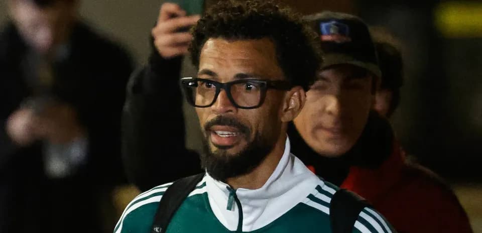 Player arriving at venue wearing team jacket
