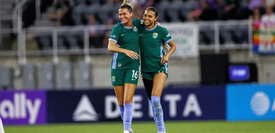 Players celebrating during NWSL match