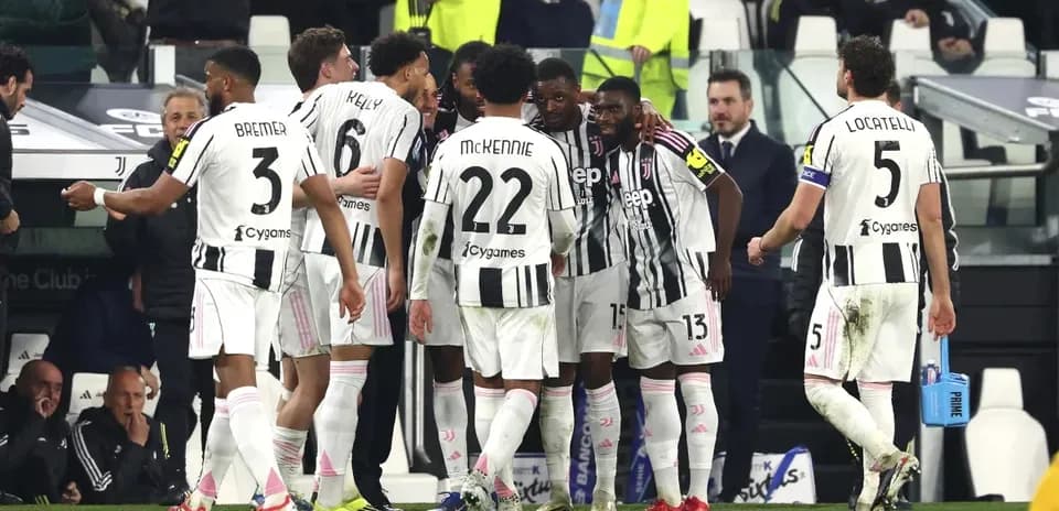 Juventus players celebrating during a match huddle