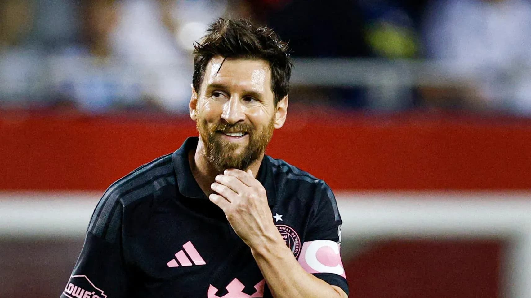 Player in black jersey smiling during match