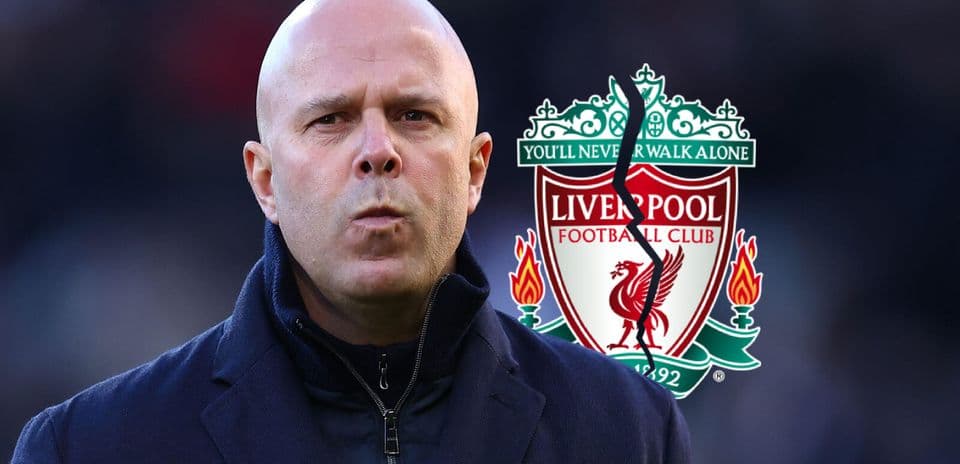 Person in front of Liverpool FC club logo