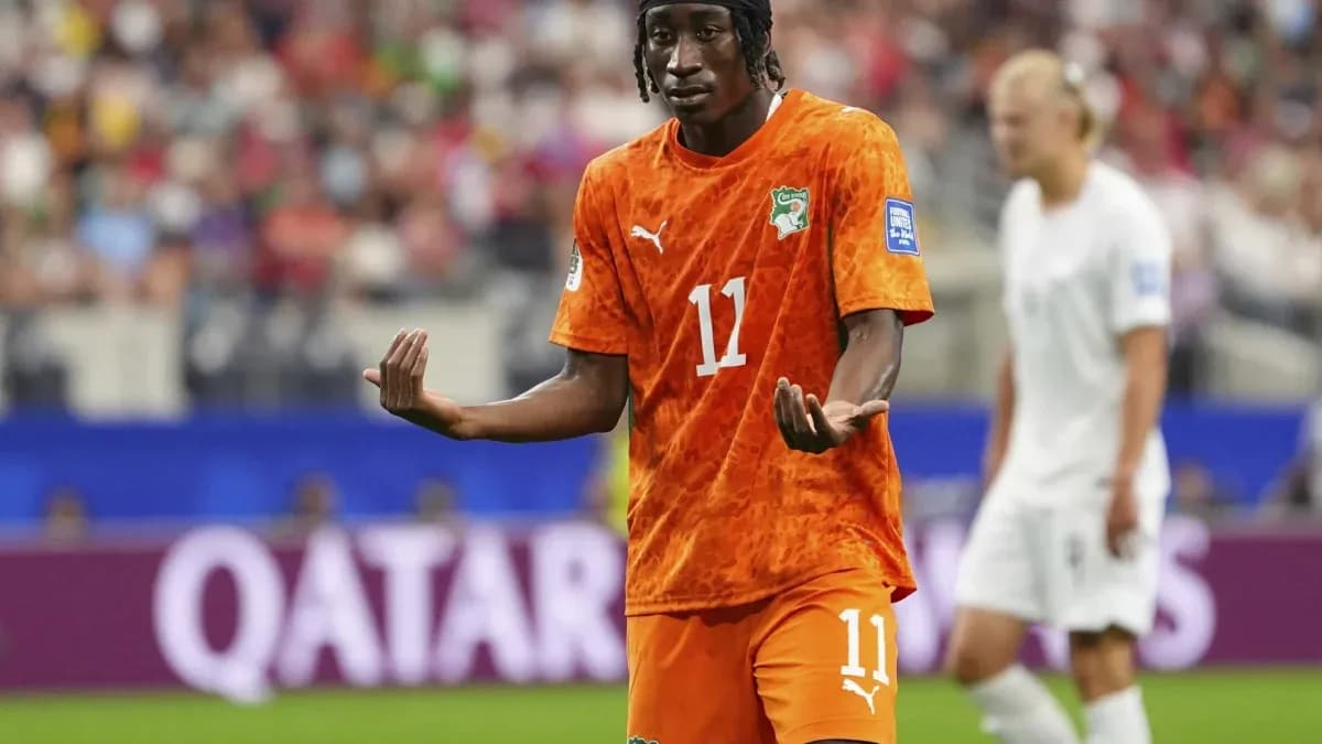 Player gesturing during match in orange jersey