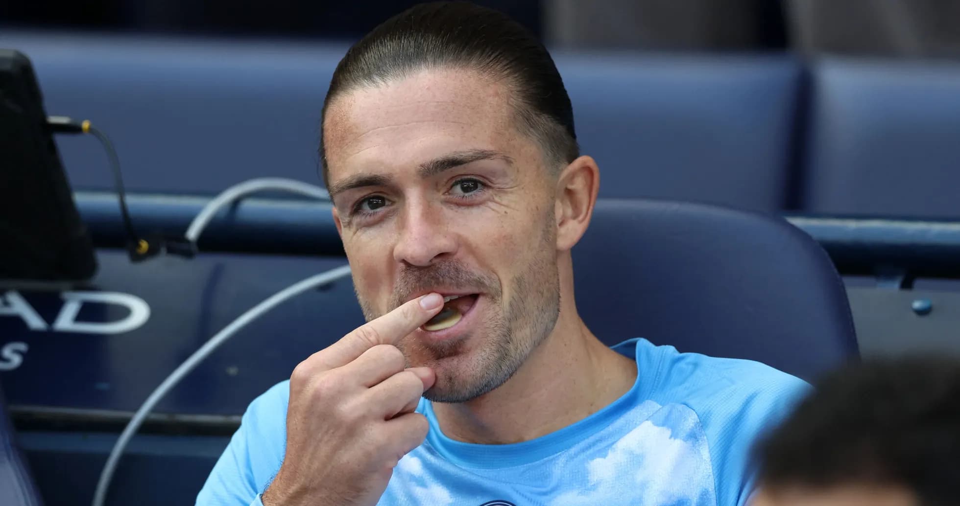 Player sitting on bench, eating before match
