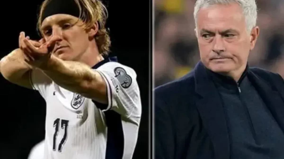Player celebrating goal alongside manager during match