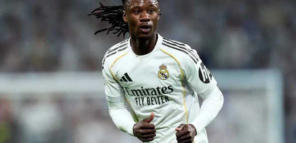 Player running on the pitch wearing Real Madrid kit