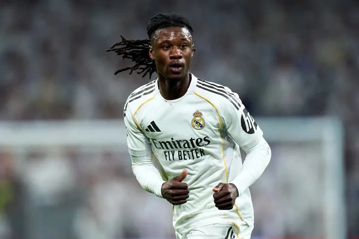 Player running on the pitch wearing Real Madrid kit