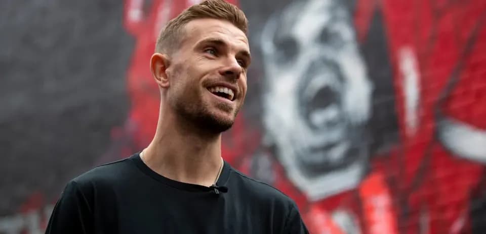 Player smiling in front of a mural backdrop