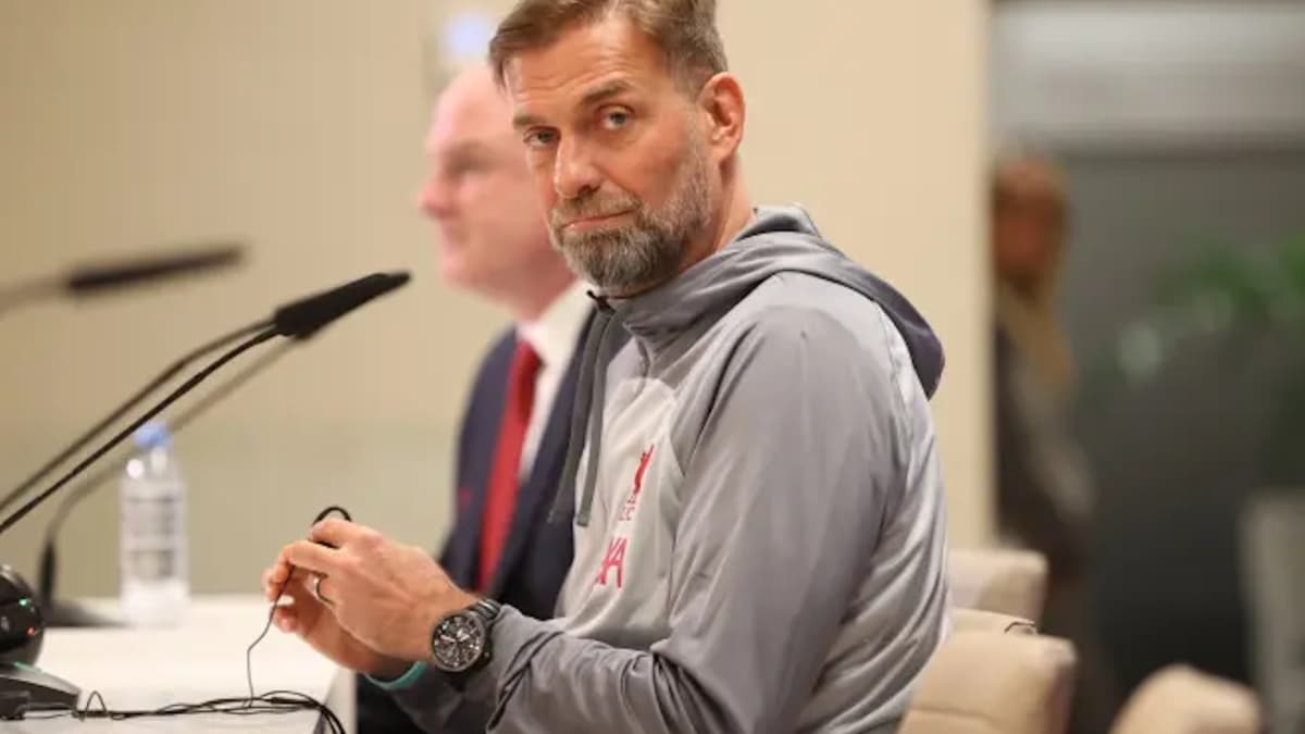 Manager speaking at press conference with microphone