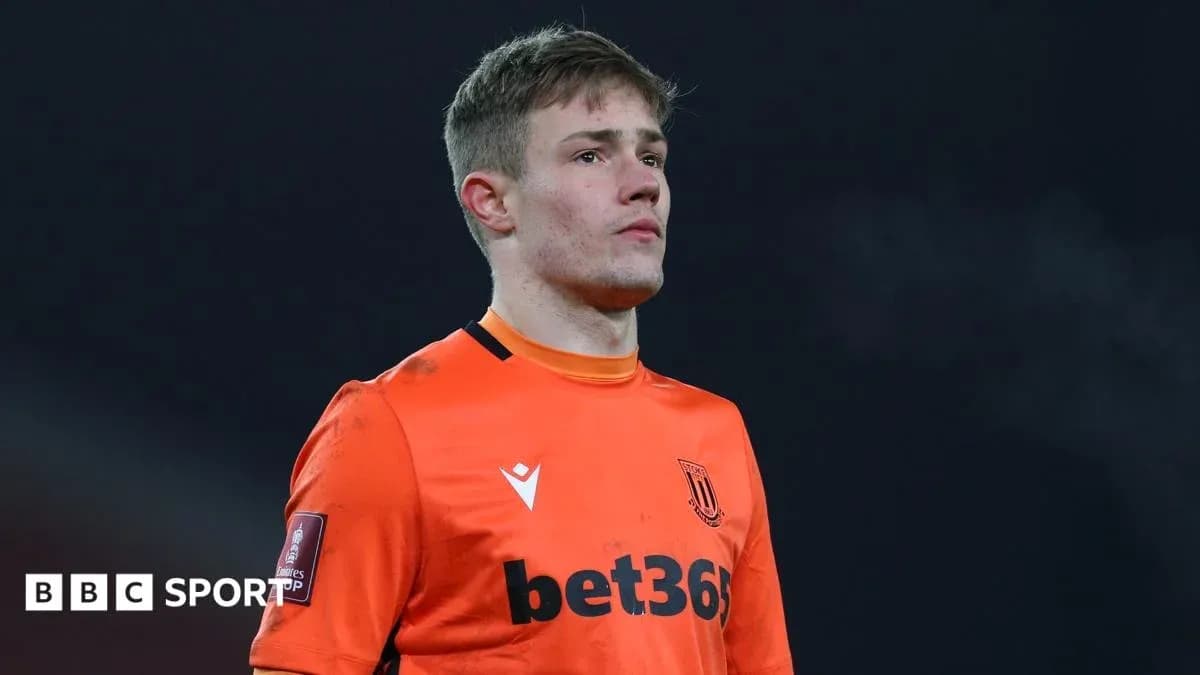 Goalkeeper in orange kit during match