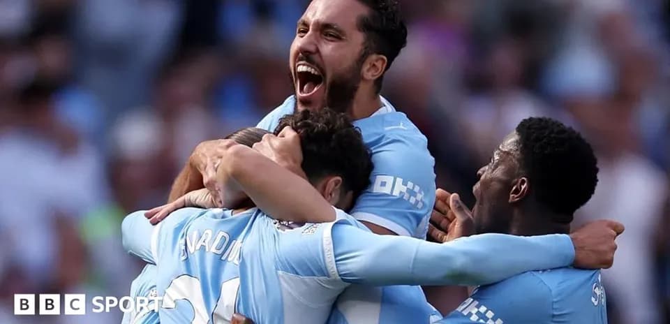 Players celebrating a goal in team uniforms