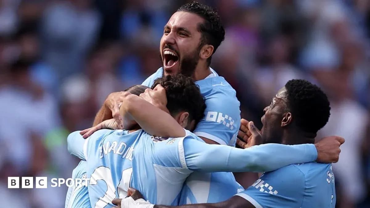 Players celebrating a goal in team uniforms