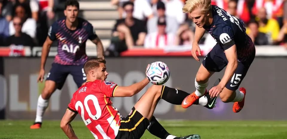 Player tackling opponent during football match action