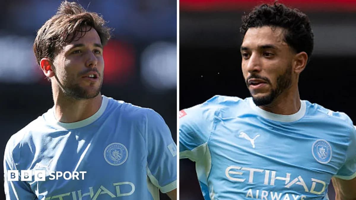 Two Manchester City players in blue jerseys