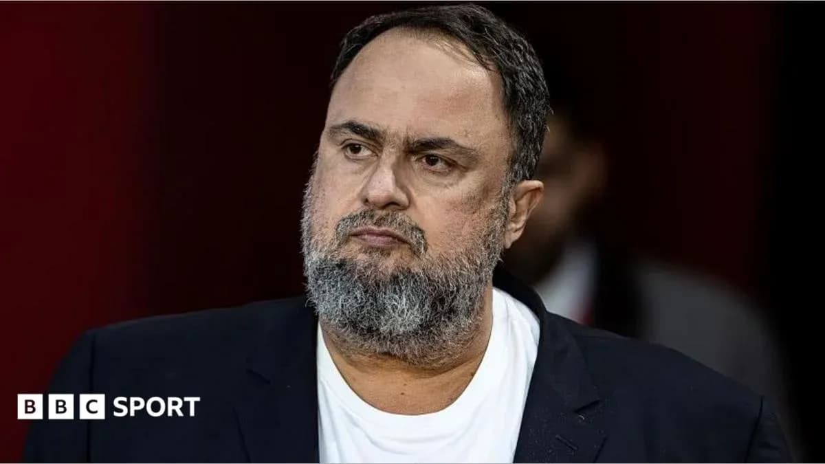 Man with beard wearing a black suit jacket