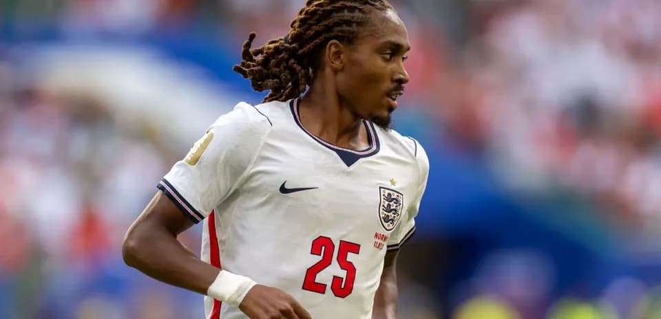Player in England jersey running on the field