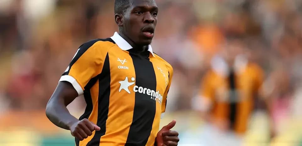 Player running in black and orange jersey on field