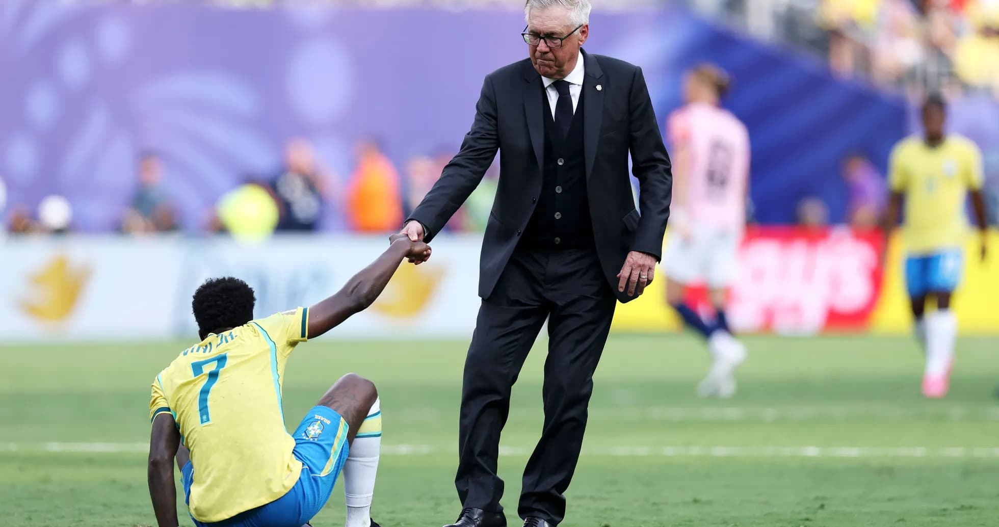 Coach helping player get up from the ground