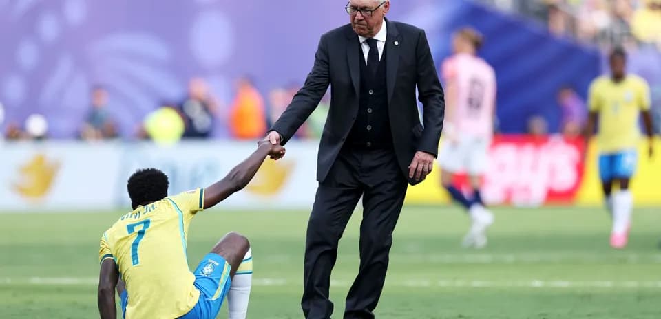 Coach helping player get up from the ground