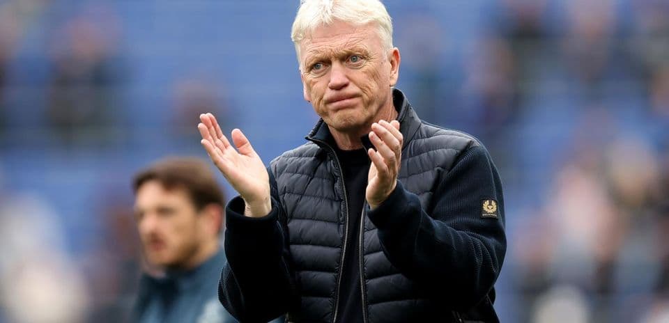 Manager clapping on the sideline during match