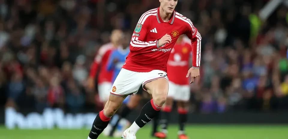 Player running with ball during Manchester United match
