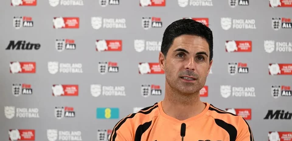 Manager speaking at press conference with England Football backdrop