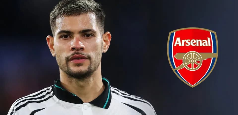Player posing with Arsenal logo in background