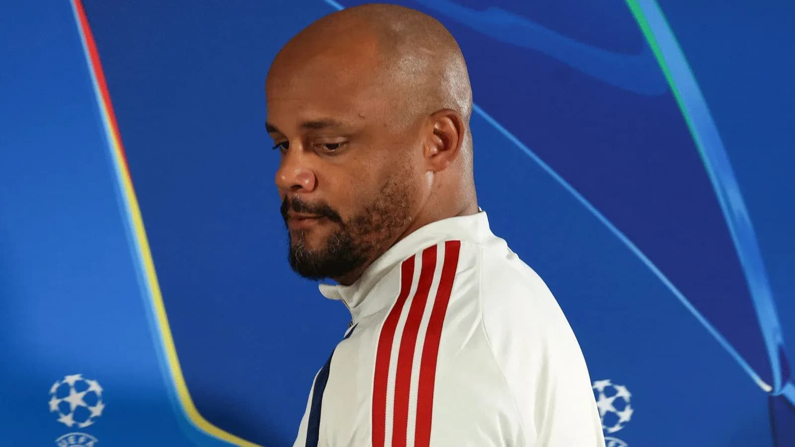 Manager walking away from UEFA Champions League backdrop