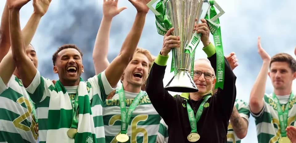 Celtic players celebrating with trophy after victory