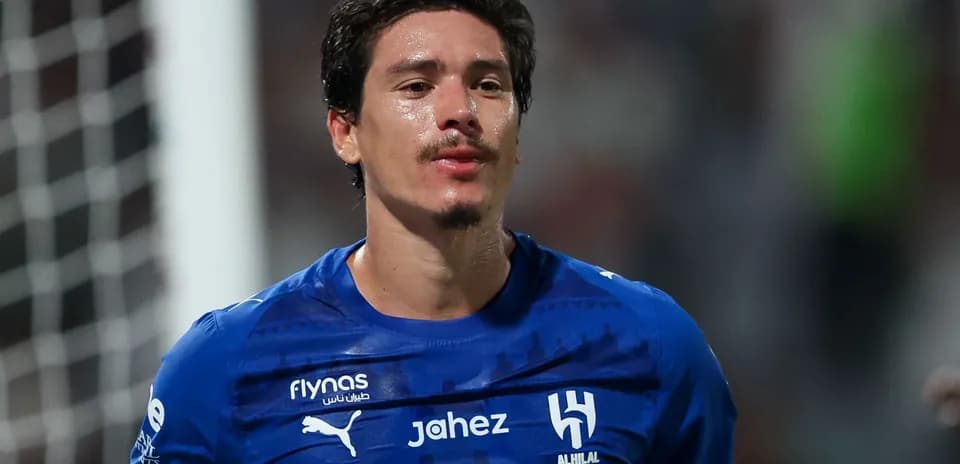 Player in blue jersey walking on the field