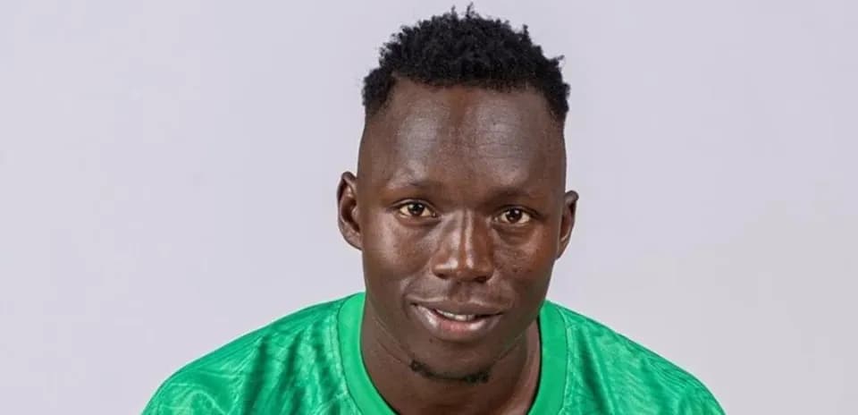 Player wearing green jersey posing for portrait