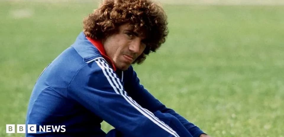 Athlete sitting on grass field in training gear