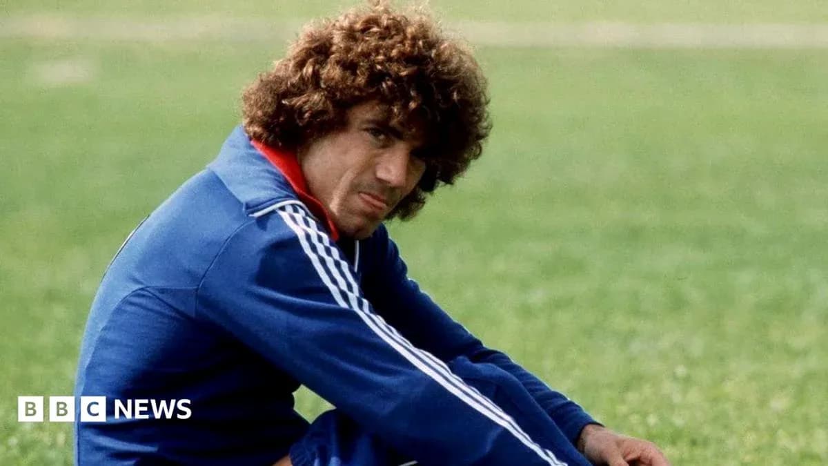 Athlete sitting on grass field in training gear