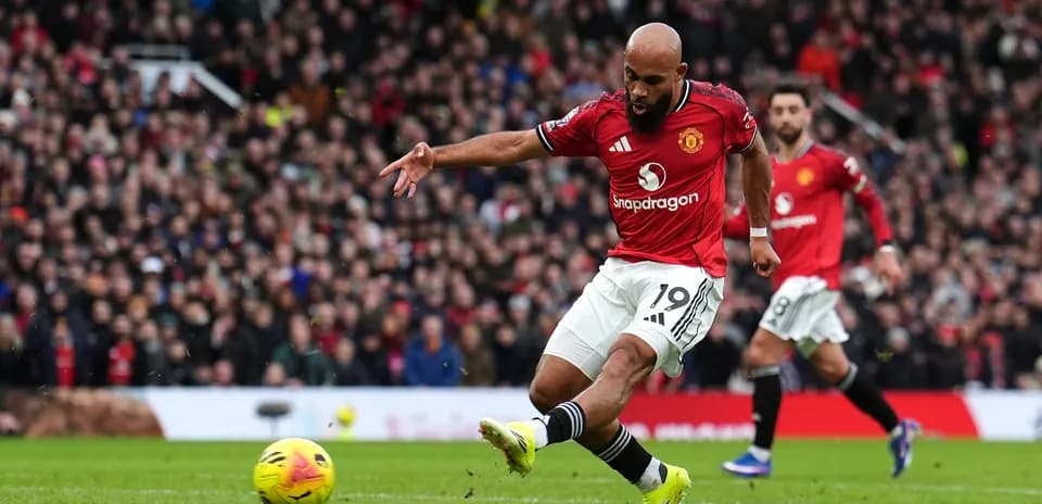 Manchester United player taking a shot on goal