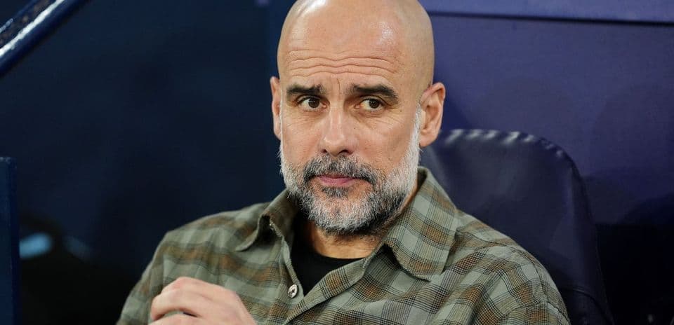 Coach seated on bench during match preparation
