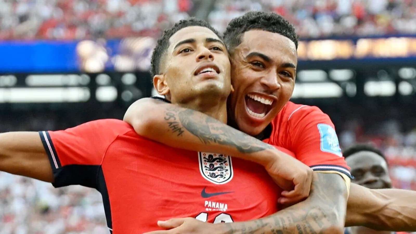 Two players celebrating a goal on the field