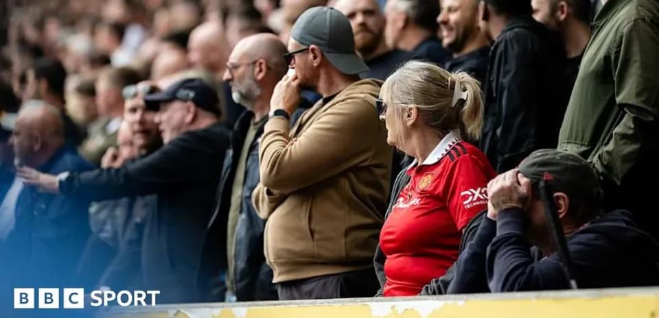Fans watching a match in the stadium