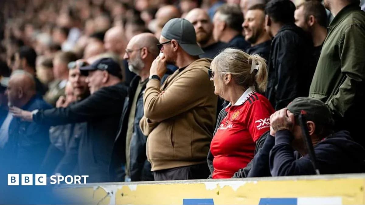 Fans watching a match in the stadium
