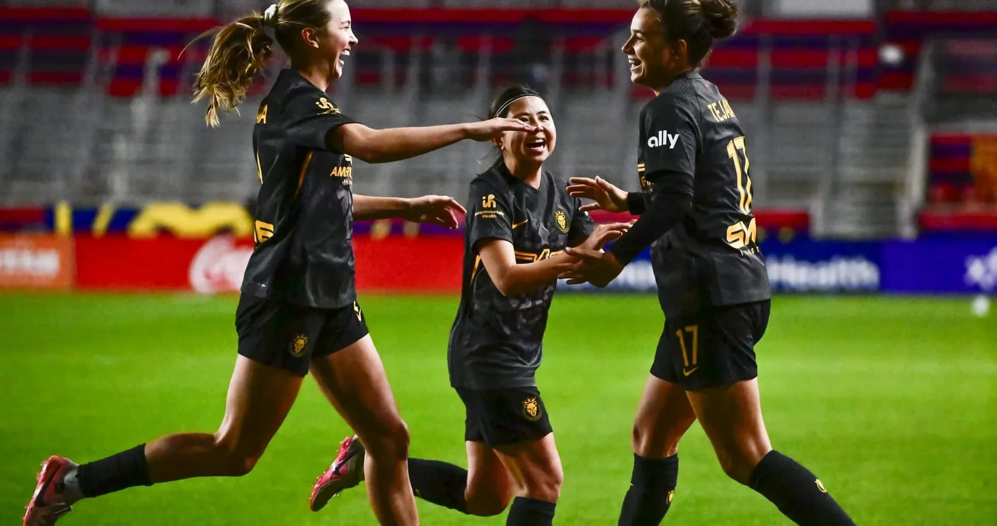 Players celebrating during NWSL match
