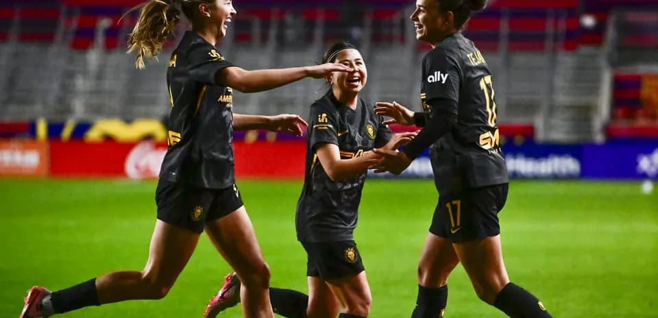 Players celebrating during NWSL match