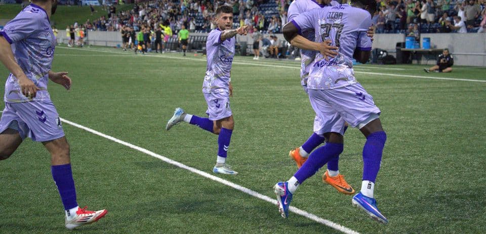 Players celebrating a goal during match