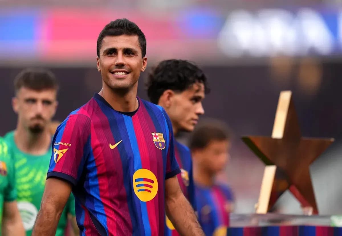 Player in FC Barcelona kit smiling during ceremony