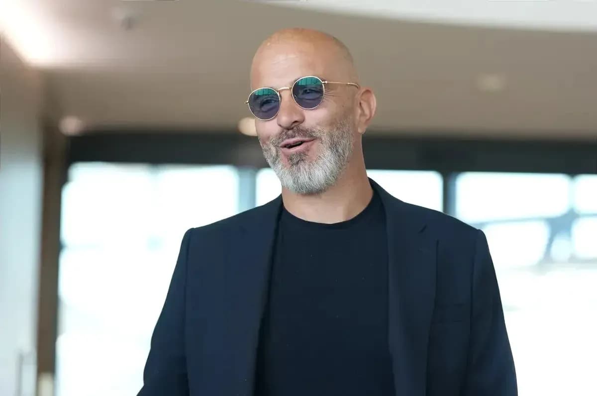 Man in sunglasses smiling indoors