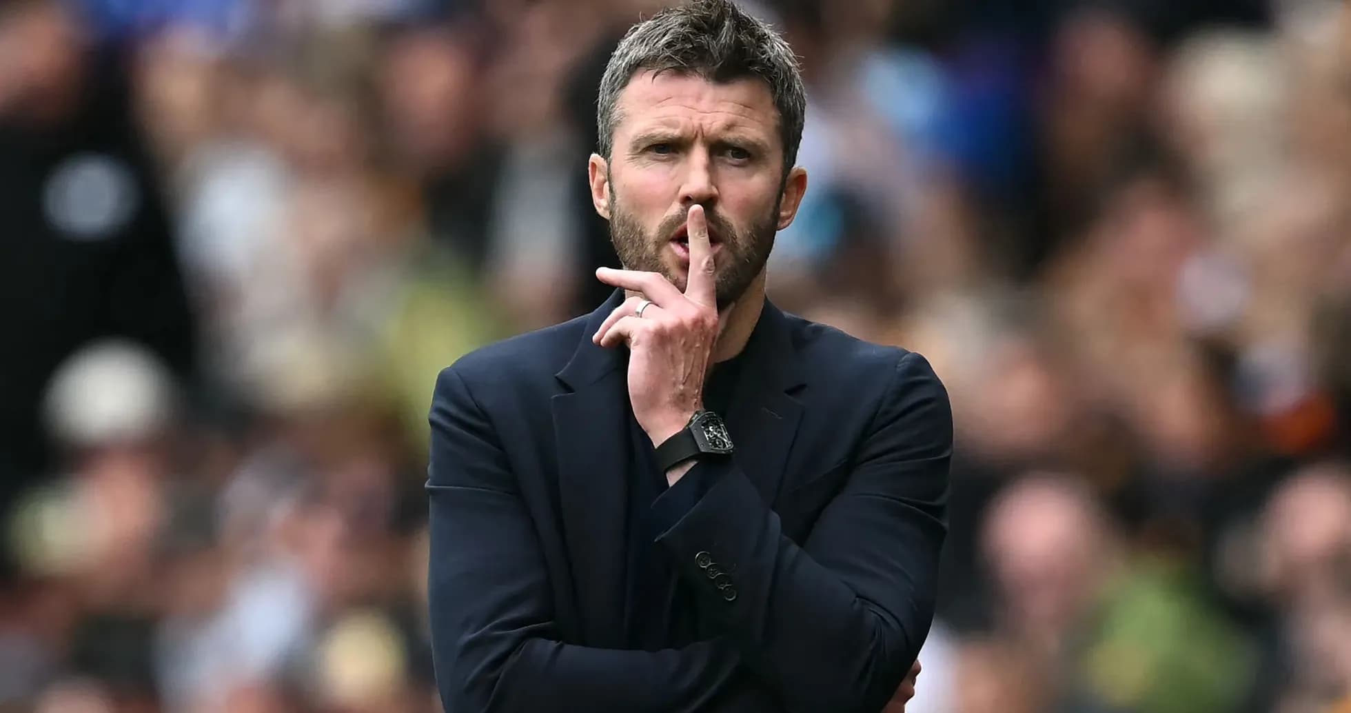 Coach gesturing for silence during a match