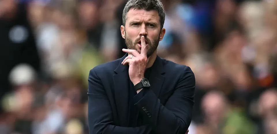 Coach gesturing for silence during a match