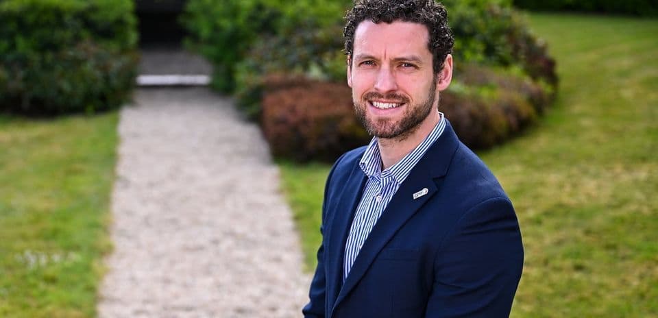 Man in suit standing on garden pathway