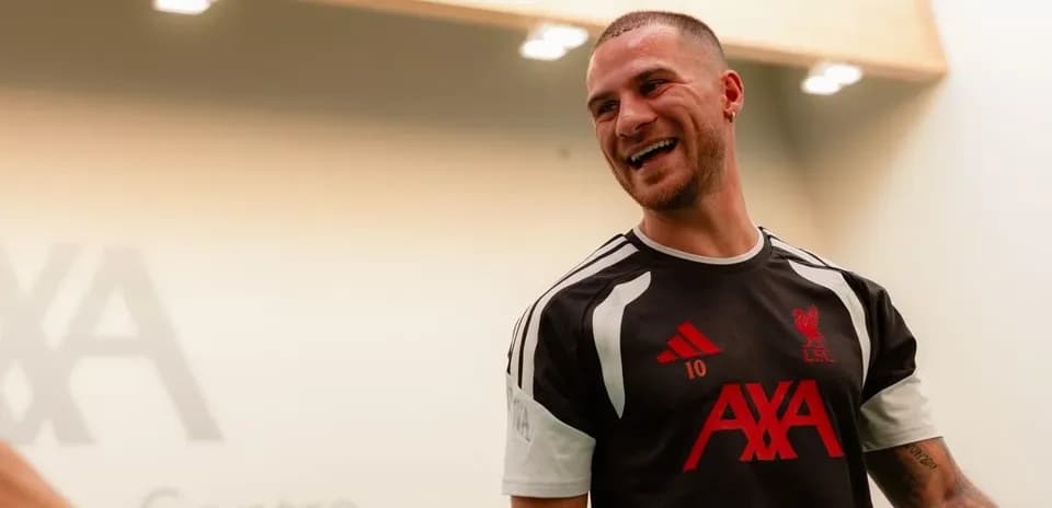 Player smiling in Liverpool training kit