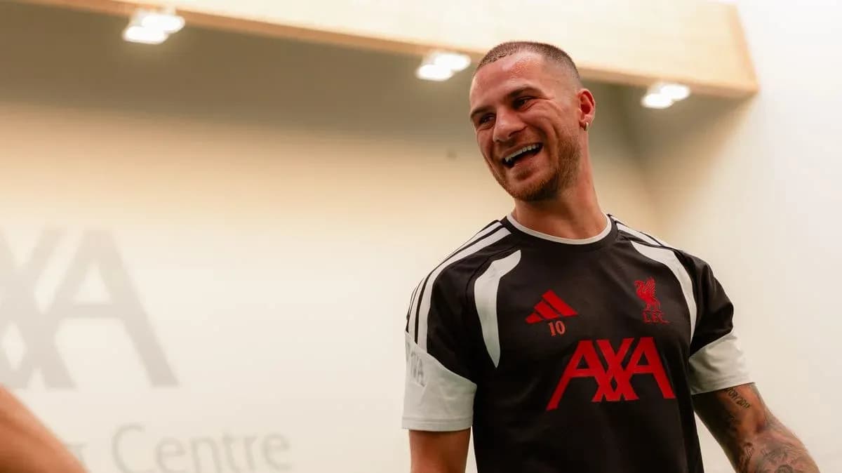 Player smiling in Liverpool training kit