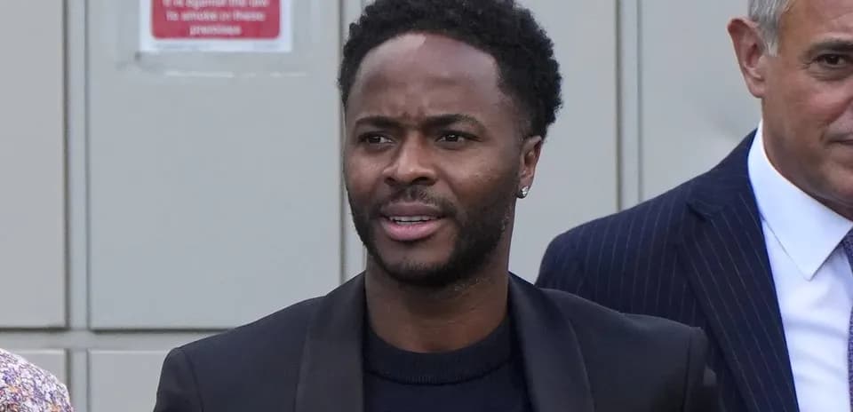 Man walking outdoors with formal attire and earring
