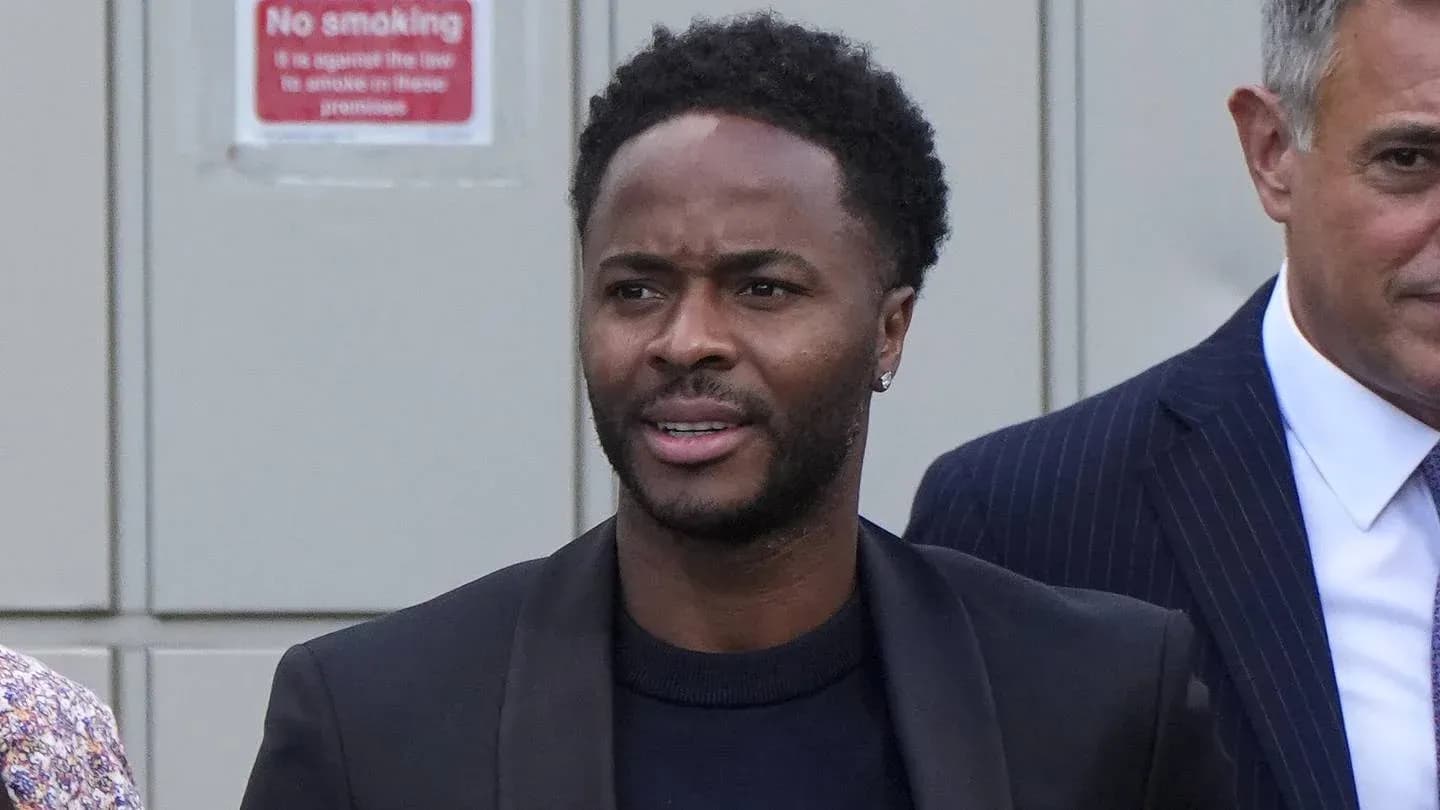 Man walking outdoors with formal attire and earring