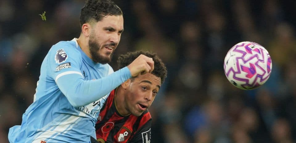 Bournemouth player challenging Manchester City opponent